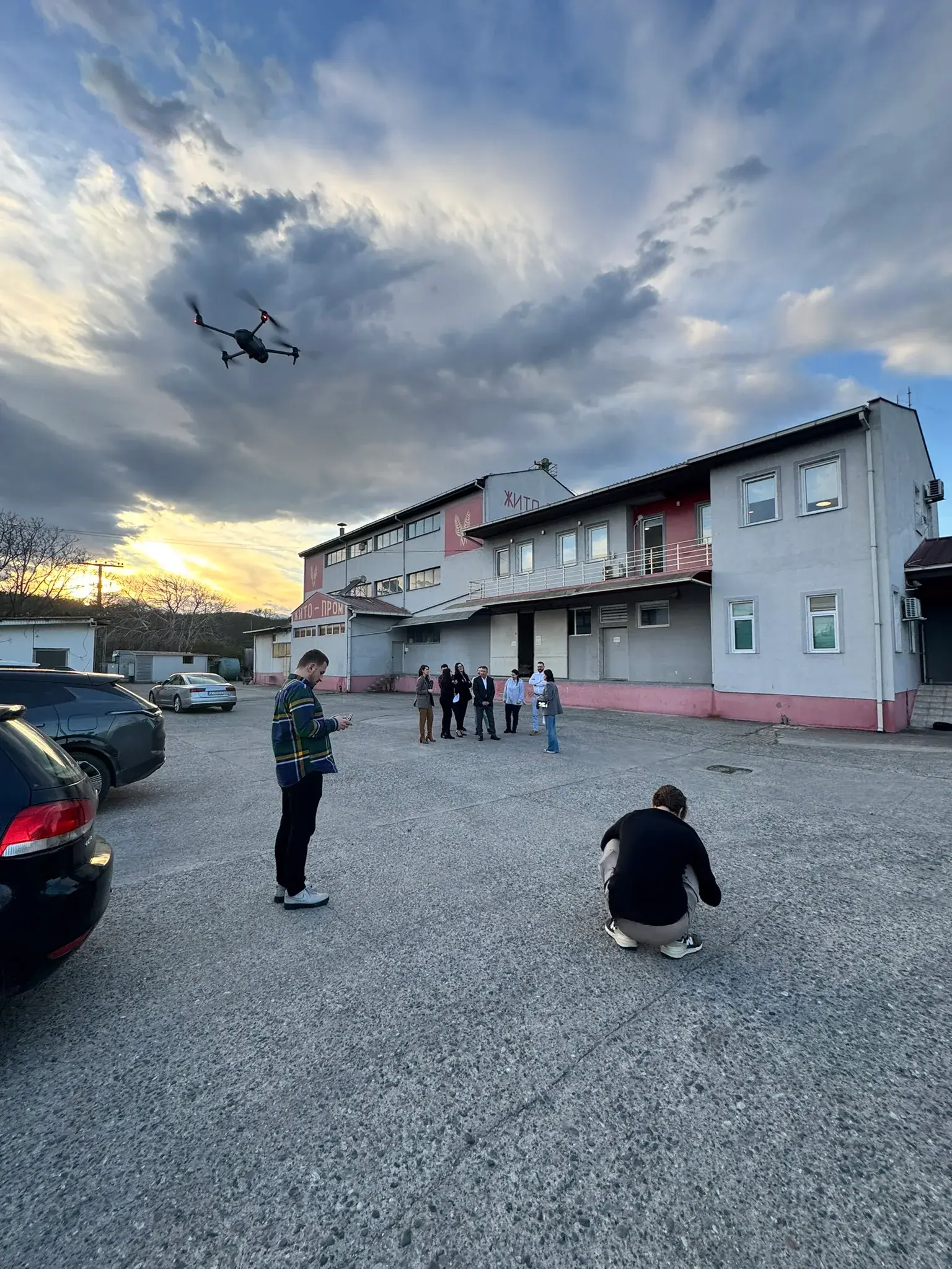 The Why Agency team working with a drone on location at sunset